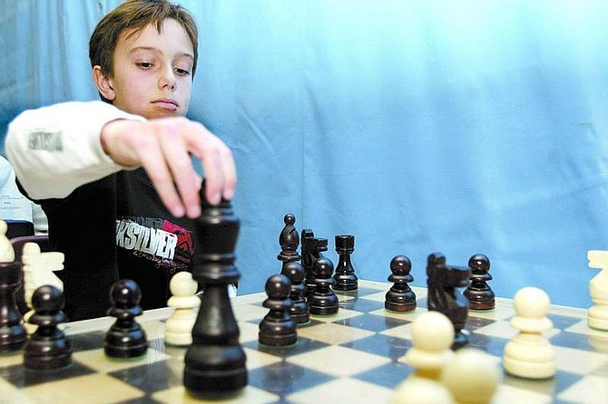 Shannon Litz/Appeal News Service Third-grader Zachary Kellar participates in the junior division of the chess tournament at Meneley Elementary School.