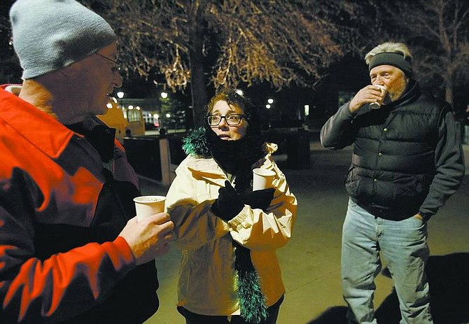 Chad Lundquist/Nevada Appeal State Assembly members David Parks, left, and Peggy Pierce brave the cold with Jon Sasser of Washoe Legal Services during the &quot;Tent City: A Night at the Legislature&quot; event on Sunday. About 200 people camped out to bring awareness to homelessness issues.