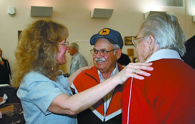 Rhonda Costa-Landers/Nevada Appeal Silver Springs Senior Center Director Bobbie Hughes, left, thanks Frank Fiorica (in hat) and his wife, Lois, for attending the open house of the Silver Springs Senior and Community Center on Tuesday.