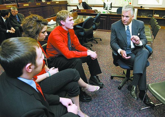 Cathleen Allison/Nevada Appeal U.S. Sen. John Ensign speaks with a group of Carson High School students Wednesday afternoon at the Legislature. From left, Adam Solinger, 18, Julia Lopez, 17, Joe Leatham, 17, and Callie Ward, 16. Kathryn Remer, 15, not shown, interviewed Ensign on a number of current events.