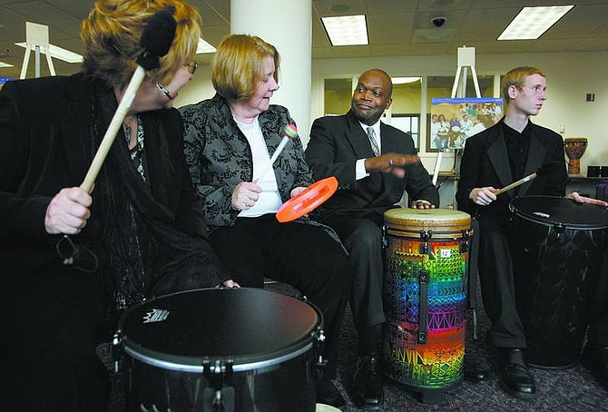 Cathleen Allison/Nevada Appeal  Assemblyman William Horne, D-Las Vegas, center, jams with a drum group at the Legislature on Thursday afternoon. Music therapy advocates, including from left, Judith Pinkerton, Judy Simpson, and Michael Burkhardt, were educating lawmakers about the benefits of group drumming and music therapy.