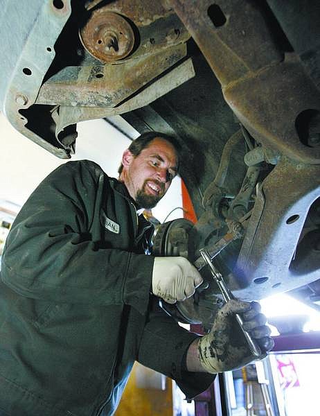 Cathleen Allison/Nevada Appeal  Brian Dyer of Dayton Valley Service repairs a truck Tuesday afternoon at his downtown Dayton shop.