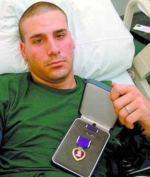 HM3 Robert Byrnes USN/Special to The R-C Pfc. Daniel Tingle with his Purple Heart medal in the hospital.