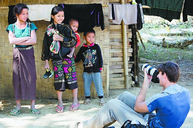 Eric Jarvis/Submitted Photo South Lake Tahoe photographer Rick Gunn has taken thousands of pictures of families during his trip around the world. Here, Gunn photographs children in an Akha village in Laos.