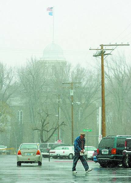 BRAD HOrn/Nevada Appeal A man walks through the Nugget Casino parking lot during a snowstorm on Sunday afternoon.
