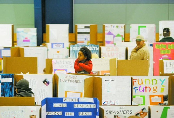 BRAD HORN/Nevada Appeal Shalie Kenney, 5, of Dayton, sits on her father, Charles&#039;, shoulders at the Dayton Intermediate School&#039;s science fair.