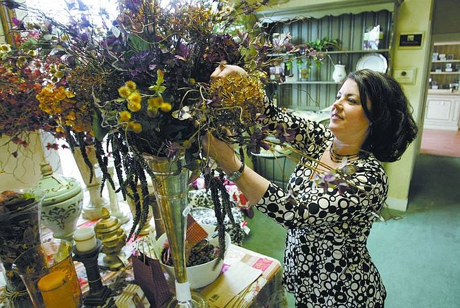 Cathleen Allison/Nevada Appeal Heather Blueberg, co-owner of Chateau Bliss, works on a flower arrangement Friday at the Carson City shop. After three years, the boutique has closed its doors.