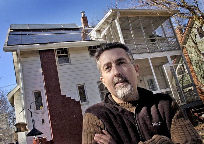 Solar panels for generating electricity and heating water are on the roof behind Mike Tidwell, an environmental activist living in Takoma Park, Md. Tidwell&#039;s house, once an ordinary 1915 bungalow, has become perhaps the closest thing to a &quot;zero-carbon&quot; home in his region. Illustrates ENERGY-HOME (category a), by David A. Fahrenthold (c) 2007, The Washington Post. Moved Tuesday, March 6, 2007. (MUST CREDIT: Washington Post photo by Gerald Martineau.)