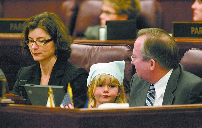 Cathleen Allison/Nevada Appeal Breanna Adams, 7, of Reno, watches the Assembly floor session Thursday morning as part of the Big Brothers Big Sisters group that visited the Legislature. Adams sat with Assemblywoman Heidi Gansert, R-Reno, and Assemblyman Garn Mabey, R-Las Vegas, as well as Gov. Jim Gibbons and first lady Dawn Gibbons, who were on the Assembly floor for Old-Timers Day, which recognizes former lawmakers.