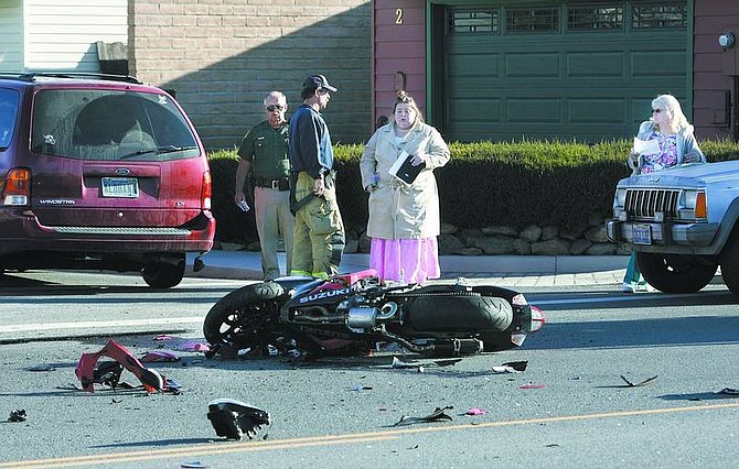 Cathleen Allison/Nevada Appeal A Carson City man was taken to the hospital Friday morning following an accident in which a mini van crossed into his path at East College Parkway and Granite Street.