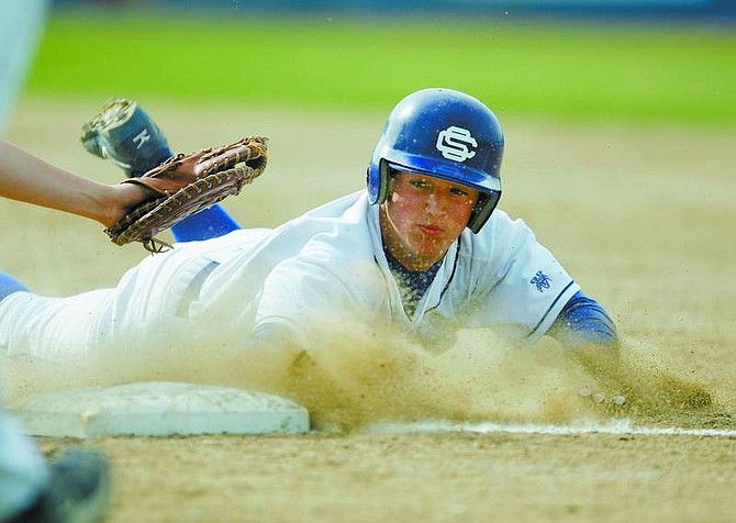 BRAD HORN/Nevada Appeal Carson&#039;s David Leid dives into first base during the Senator&#039;s game against South Lake Tahoe at Ron McNutt Field on Thursday.
