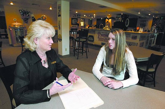 Cathleen Allison/Nevada Appeal Carson High School senior Lindsay Ford, 18, works with Terrie McNutt at Coaches banquet room at Silver Oak Golf Course on March 20. Ford&#039;s senior project is coordinating the Senior-Senior prom, which will be held at Coaches.