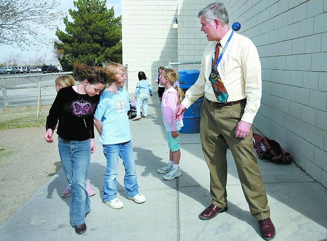 Chad Lundquist/Nevada Appeal Dayton Elementary School Principal Nolan Greenburg talks with third-grade students Stella Taylor, 8, and Lauren Bailey, 8, Monday after school. Greenburg will take over Dayton Elementary School III next year.