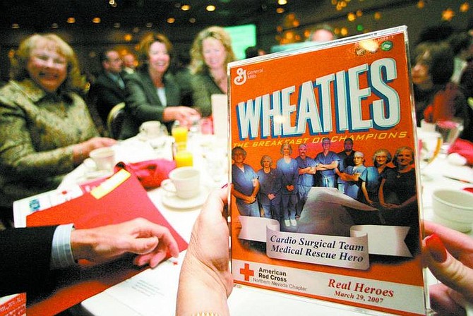 A member of the Carson Tahoe Regional Medical Center&#039;s Cardio Surgical Team displays the team&#039;s photo on the cover of a Wheaties box during the Red Cross Real Heroes Breakfast on Thursday at Harrah&#039;s inReno. The team was nominated and won for saving Chris Campos&#039; life during emergency surgery for an aortic aneurysm.