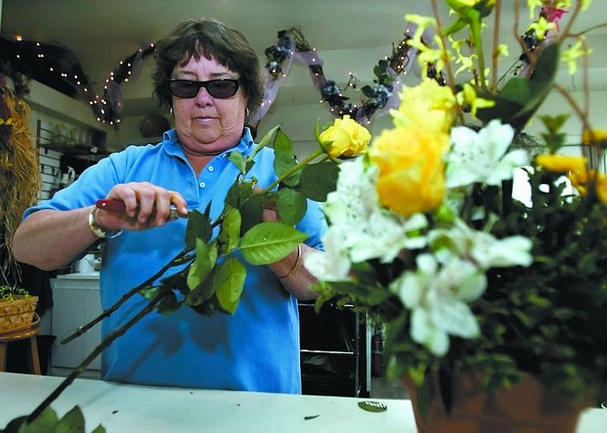 Chad Lundquist/Nevada Appeal Gretchen Beitel works on a bouquet Wednesday at Dayton Valley Floral &amp; Nursery.