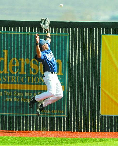 BRAD HORN/Nevada Appeal WNCC&#039;s Pat Grennan reaches for a home run ball at John L. Harvey Field on Friday.