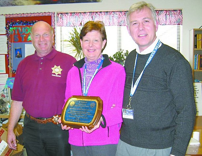 Dayton Elementary teacher Linda Peterson was awarded the 2006-2007 DARE Teacher of the Year award by Lyon County&#039;s DARE officer, Bob Kahn, left, and Dayton Elementary principal Nolan Greenberg.   Photo submitted
