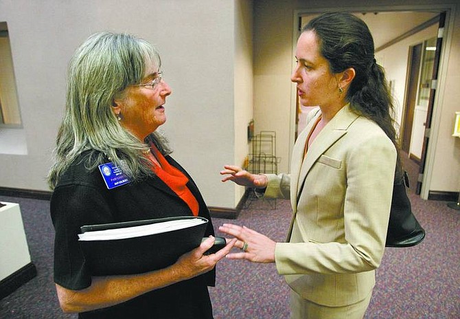 Cathleen Allison/Nevada Appeal Lobbyists Jan Gilbert, left, and Pilar Weiss talk Friday at the Legislature. They oppose a bill being considered by lawmakers that would make English the official language for state business.
