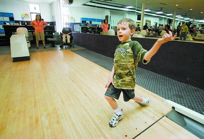 BRAD HORN/Nevada Appeal Quinn Rondeau, 5, of Virginia City, celebrates a spare on Saturday at the Carson Lanes. His brother Jacob, back, and mother Jenna were celebrating Jacob&#039;s 20th birthday at the event.