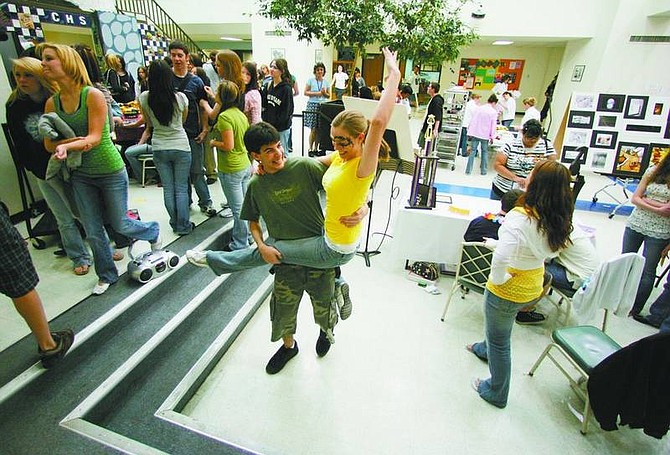 BRAD HORN/Nevada Appeal Ben Guberman, 16, dances with Carinne Powell, 17, during the occupational fair at Carson High School on Thursday. The students are in theater and concert choir.