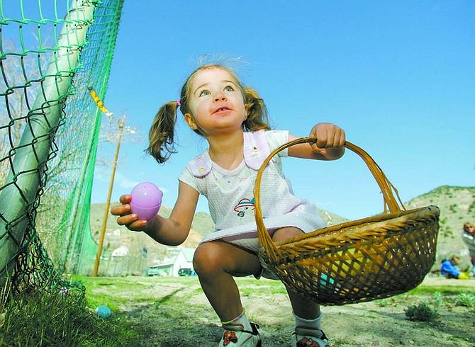 BRAD HORN/Nevada Appeal Norissa Lockhart, 3, of South Lake Tahoe, finds her first egg during her first Easter Egg hunt during the Great Virginia City Easter Egg Hunt on Saturday at Miner&#039;s Park.