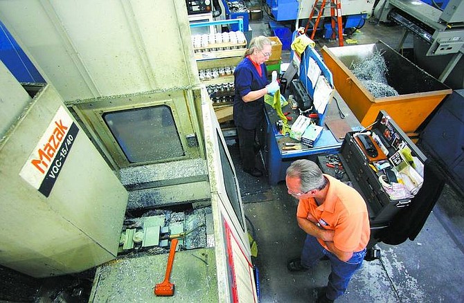 BRAD HORN/Nevada Appeal Ken Taylor, front, manufacturing manager for Mr. Gasket, works in the shop on Wednesday.