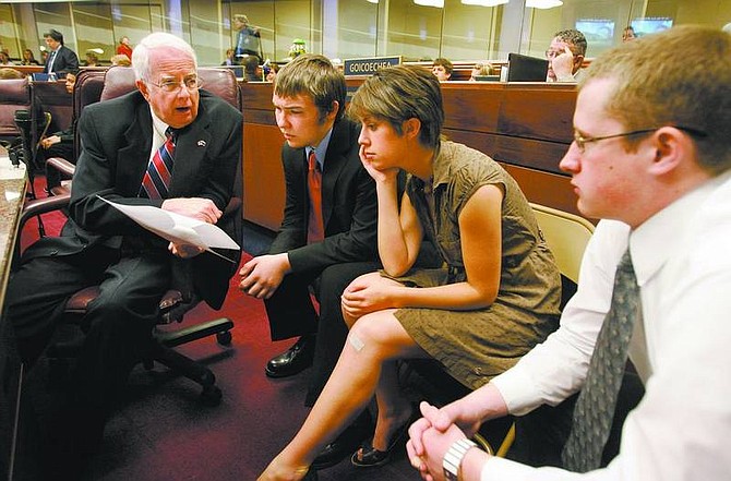 Cathleen Allison/Nevada Appeal Carson High Schools students, from left, Adam Solinger, 18; Destiny Casci, 17; and Ryan Keating talk with Assemblyman Lynn Stewart, R-Henderson, on Tuesday before the Assembly floor session. They were part of a group of 52 Northern Nevada students who participated in State Government Day.