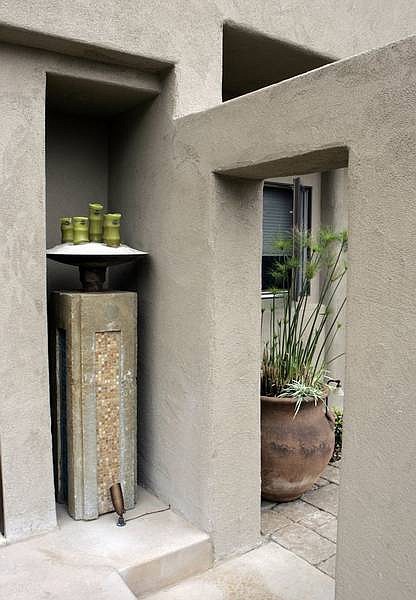 Stephen Osman/Los Angeles Times Stone niches showcase a candle stand and water fountain that capture the energetic vibe of the outdoors.