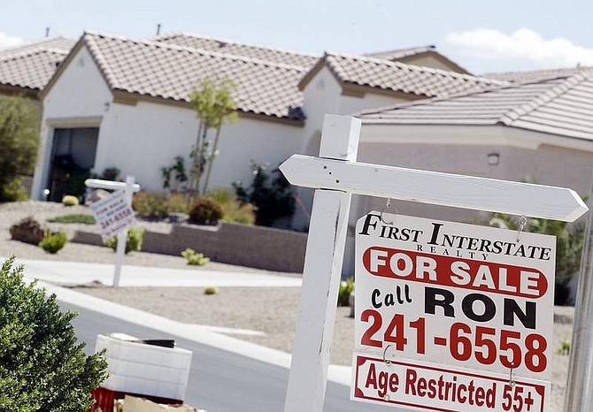 Isaac Brekken/Associated Press &quot;For sale&quot; signs hang in front of homes on Cumberland Hill Drive in Henderson, outside Las Vegas on Tuesday.