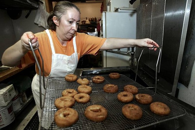 Elvira Diaz, owner of Sierra  Bakery, fries  doughnuts at her  shop in  preparation for Mexico&#039;s day to honor workers today. Diaz said Cinco de Mayo is not  celebrated as a party in Mexico, but more as a civic  celebration.  Chad Lundquist/ Nevada Appeal