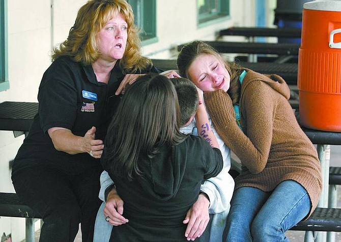 Cathleen Allison/Nevada Appeal Terressa Baker, with the Boys &amp; Girls Club of Western Nevada, comforts a group of students Friday after they learned of the death of Carson City teen Joe Molter. From front left are Cindy Gutierrez, 12, Mike Coyner, 16, and Jacquelyn Conard, 13.