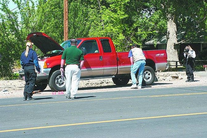 Rick Norton/Appeal News Service Investigators with the Lyon County Sheriff&#039;s Office examine a truck following a shooting Saturday morning on Farm District Road in Fernley. Shelby Joanette, 36, suffered gunshot wounds and was transported by a Care Flight helicopter to an area hospital.