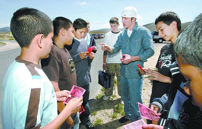 Cathleen Allison/Nevada Appeal Jeremiah Smith, center, talks about methamphetamine awareness with Eagle Valley Middle School students Tuesday afternoon. Smith, and several members of the Potters House Christian Church were handing out fliers to Carson City students to invite them to the free play, &quot;The Life of Crystal,&quot; which will be 8 p.m. Friday at the Plaza Motel Conference Center.
