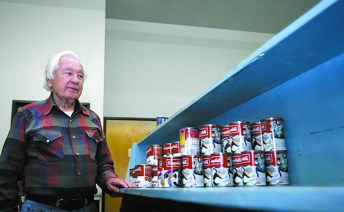 Chad Lundquist/Nevada Appeal FISH Food Pantry Manager Jim McMullen looks over mostly empty pantry shelves Wednesday afternoon. FISH is one of the recipients of Saturday&#039;s Stamp Out Hunger food drive by the National Association of Letter Carriers.