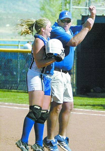 Cathleen Allison/Nevada Appeal Coach Jon Grant celebrates with Carson&#039;s Abby Rankl after she got the game-winning hit in Thursday&#039;s 13-3 zone victory over McQueen.