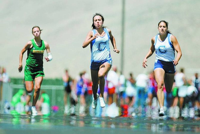 BRAD HORN/Nevada Appeal Carson&#039;s Kayla Sanchez, center, and Andrea Keirstead compete in the 200 meter finals at Damonte Ranch High School on Saturday. Sanchez finished first.