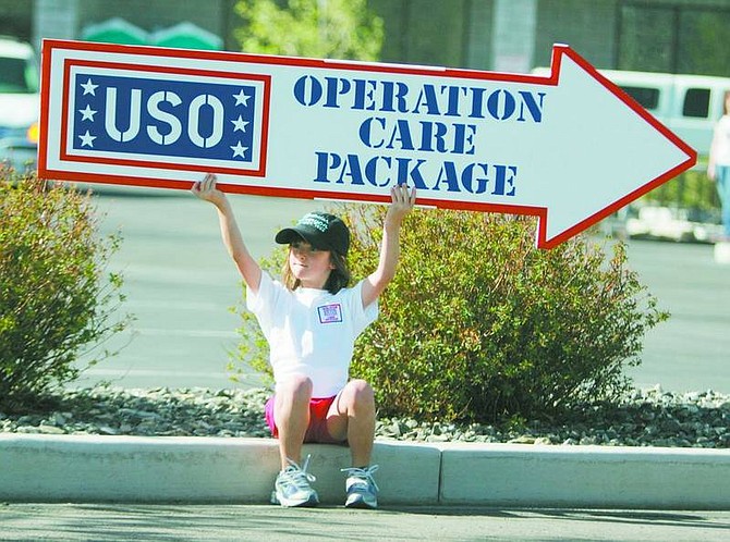 BRAD HORN/Nevada Appeal Megan Gaskill, 6, of Minden, holds a sign directing motorists to the USO&#039;s Operation Care Package event on Saturday.