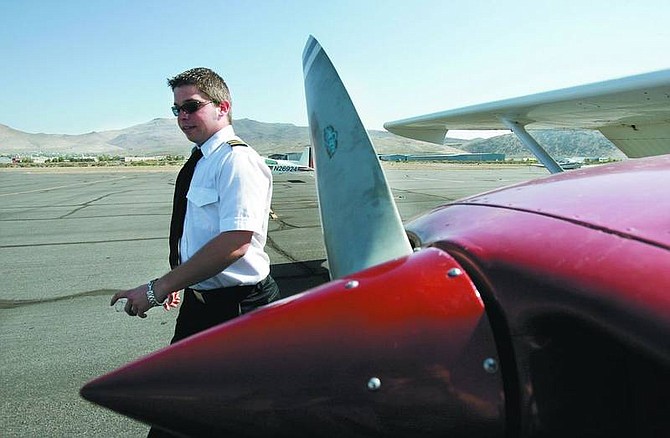Cory Miller, 21, a flight instructor for the National Pilot Academy, inspects the Cessna aircraft used for lessons. The Lyon County Fly-In scheduled to bring 60 airplanes and 3,000 people to the Silver Springs Airport on Saturday and Sunday.