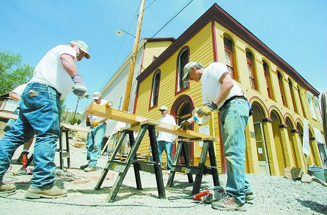 BRAD HORN/Nevada Appeal Charlie McIlvain, of Grandbury, Texas, left, and Keith Griffalt, of Salt Lake City, stain wood for stairs at Piper&#039;s Opera House on Friday as part of a citywide restoration project in Virginia City.