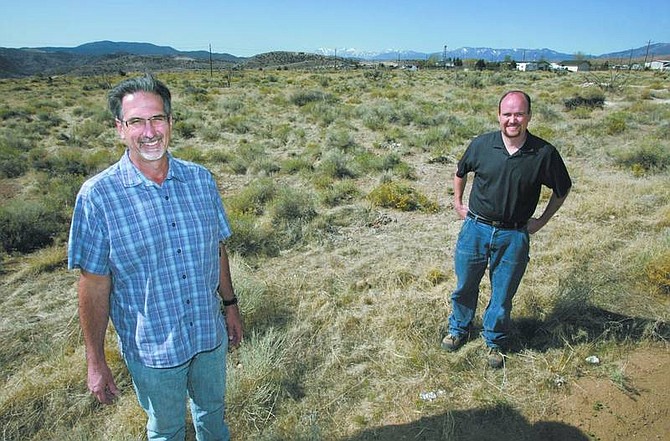 Cathleen Allison/Nevada Appeal Bill Miles, of Miles Construction, left, and CPA Phil Cowee stand in an area in Mound House where their proposed development will be.