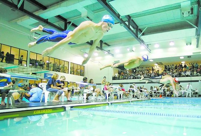 BRAD HORN/NevAda Appeal Carson&#039;s Matt Grunert flies out of the blocks for the 100-yard freestyle at the NIAAState Swimming and Diving Championships Saturday in Reno.