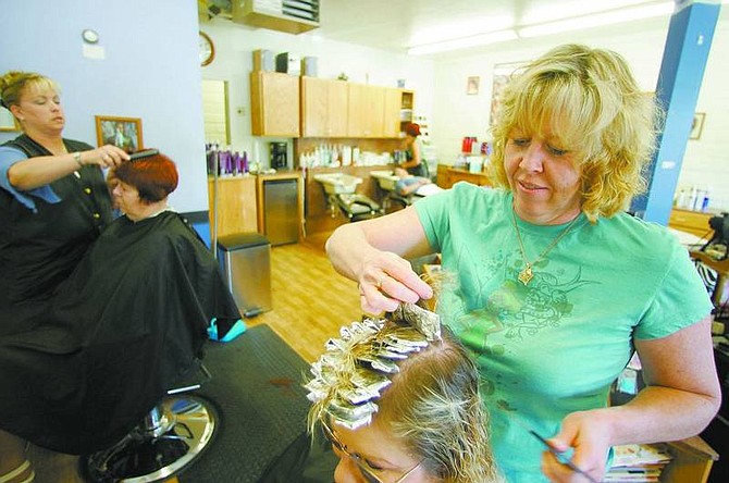 BRAD HORN/Nevada Appeal Dayton Hair Salon owner Pam Brann puts highlights in a clients hair at the salon on Wednesday afternoon. Brann has worked at the salon, the first strip mall in the area for 17 years and has owned it for almost 11.