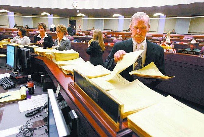 Cathleen Allison/Nevada Appeal Nevada Assembly Sergeant-at-Arms Terry Sullivan and other Legislative staff members sort copies of more than a dozen amendments before the Assembly floor session Thursday at the Legislature. Lawmakers continued jamming bills through Thursday, and while they remain hung up on key budget items, they expect to break the impasse this weekend.