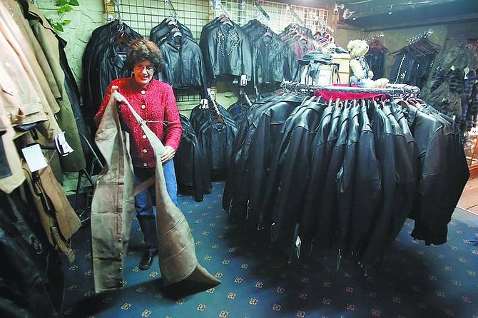 BRAD HORN/Nevada Appeal Judy Cohen rearranges some leather wear at her shop Silver Stope in Virginia City on Wednesday.