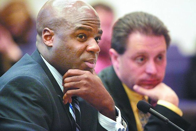 Cathleen Allison/The Nevada Appeal Nevada Assemblyman Kelvin Atkinson, D-North Las Vegas, left, listens during a joint transportation hearing Friday at the Legislature. The day after an agreement was announced, lawmakers continue to debate additional revenue sources for Nevada&#039;s highway funding crisis. Legislative fiscal analyst Russ Guindon, right, also testified.