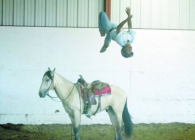 Brad Horn/Nevada Appeal Inmate Chris Baker performs a back flip off Moonshine during a horse auction at Warm Springs Correctional Center in Carson City on Saturday. The inmates saddle-train the horses, which range in age from two to five years, for 120 days.