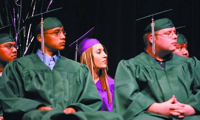 Chad Lundquist/Nevada Appeal Molly Marie Mygatt, center, listens to the graduation ceremony speech along with classmates from Pioneer High School at the Carson City Community Center on Tuesday night. Left to right, Nicholas Perez, Jose Elizondo, Lance Cowperthwaite, Derek Moyle.