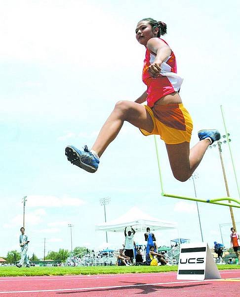 Published Caption: Dan Thrift / Tahoe Daily Tribune /  Whittell High&#039;s Jessica Woods bounds to a first place finish in the triple jump Saturday during the NIAA State Track and Field Championships at Reno High in Reno.