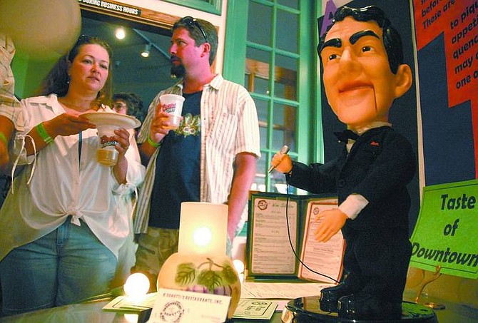 Kevin Clifford/Nevada Appeal A singing Dean Martin doll welcomes guests David McCullen and Lori Wyatt to B&#039;Sghetti&#039;s Restaurant during the 13th annual Taste of Downtown last year. The event is fundraiser for Advocates to End Domestic Violence.