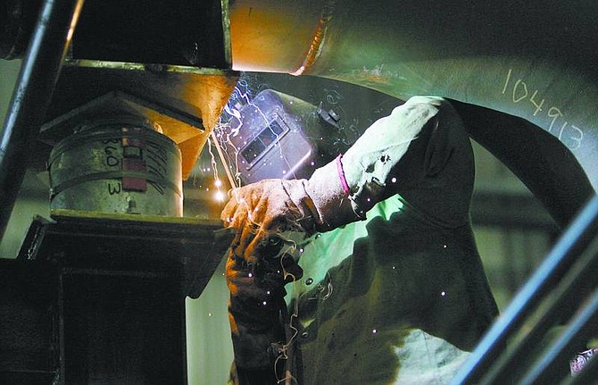 Cathleen Allison/Nevada Appeal Frank Smith, with APS Energy Services of Phoenix, welds on the steam turbine at the biomass plant at the Northern Nevada Correctional Center on Wednesday afternoon. The wood-fired power plant is due to go online in early July.